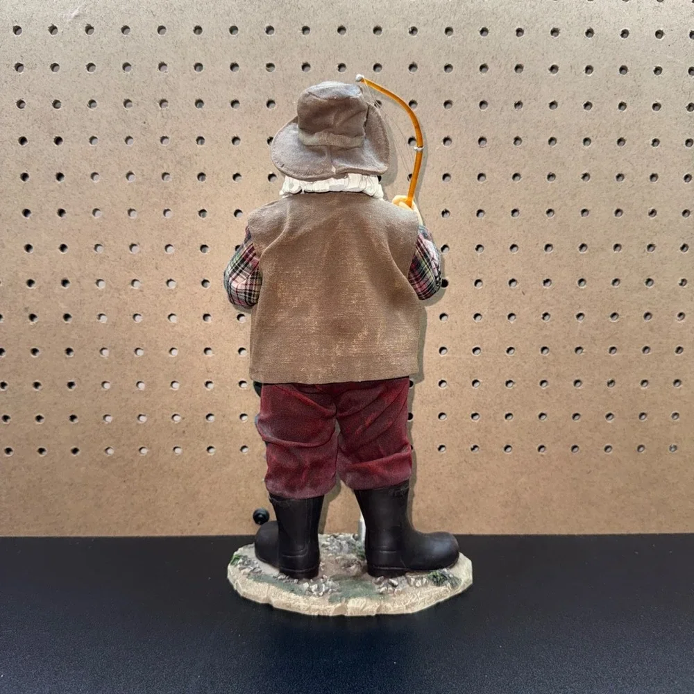 Christmas 2005 Santa fishing figurine holding a fishing pole and fish plastic